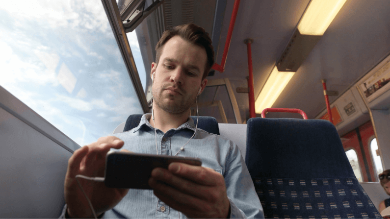 Man using phone technology on UK rail 